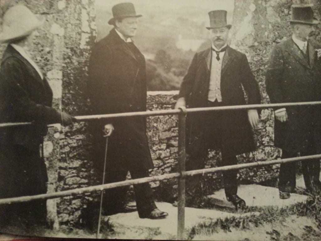British Primeminister & renowned orator, Winston Churchill, at the Blarney Stone. Image Source: /oldphotosofcork.wordpress.com