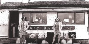 Freda Hayes standing outside the original Blarney Handcrafts thatched cottage shop in Blarney, County Cork, 1969