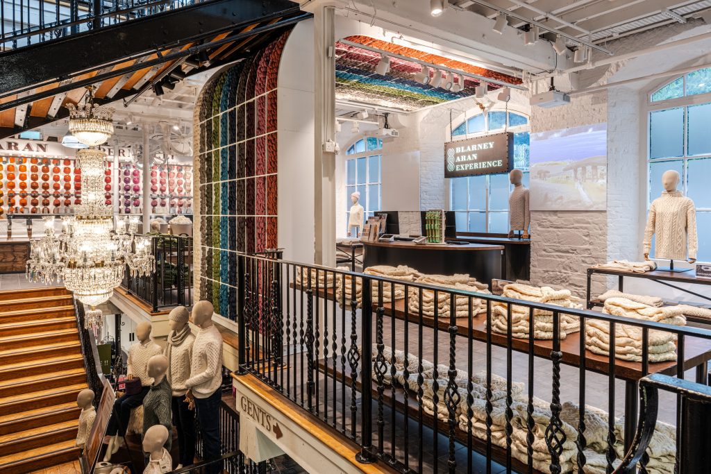 Blarney Aran Experience at Blarney Woollen Mills in Cork, showcasing Irish Aran sweaters, colourful yarn walls, and heritage mill architecture